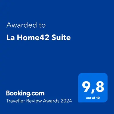 a screenshot of a phone with the text awarded to la home suite at La Home42 Suite in Palermo