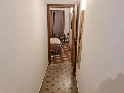 a hallway with a door open to a bedroom at Agorà Sant’anna Apartment in Palermo