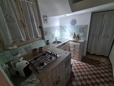 a small kitchen with a stove and a sink at Agorà Sant’anna Apartment in Palermo