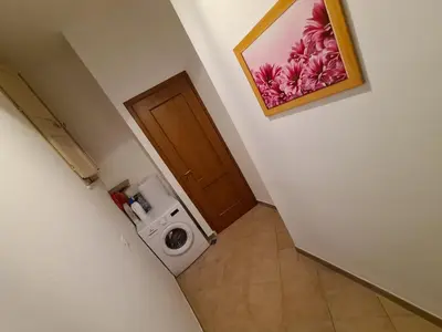 a bathroom with a washing machine and a door at Agorà Sant’anna Apartment in Palermo