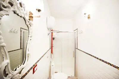 a bathroom with a shower and a mirror at Luxury Apartment Via Genova in Palermo