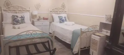 a bedroom with two beds and a dresser at Luxury Apartment Via Genova in Palermo