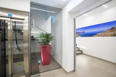 an elevator in a building with a potted plant at Sundeck Hotel in San Vito lo Capo