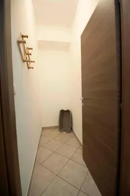 a hallway with a door and a suitcase in a room at Casa vacanza da Marisa in Partinico