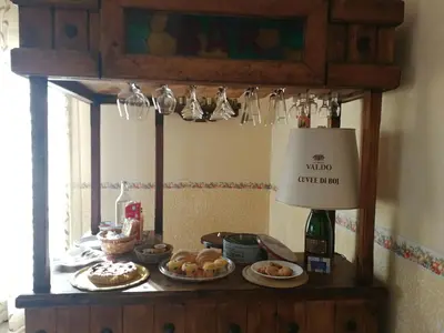 a table with plates of food and a bottle of wine at Dimora Di Campagna in Portella di Mare