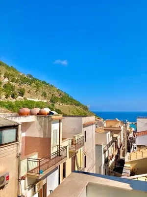 a group of buildings with the ocean in the background at Casa Colore Attic in Castellammare del Golfo
