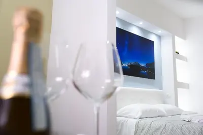 a wine glass in a room with a tv on the wall at GUEST HOUSE PIANA DEGLI ALBANESI in Piana degli Albanesi