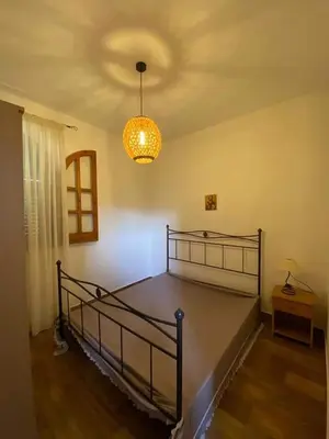 a bedroom with a bed and a chandelier at Casa Vacanza in Trabia
