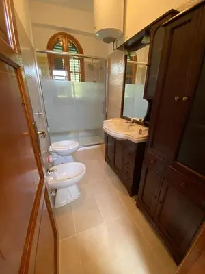 a bathroom with two toilets and a sink and a mirror at Casa Vacanza in Trabia
