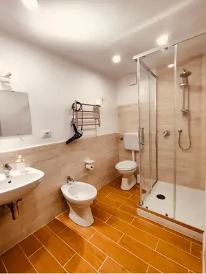 a bathroom with a toilet and a sink and a shower at Normanni Central House in Palermo