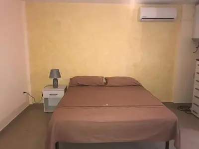 a bedroom with a bed and a lamp on a night stand at Casa Casteldaccia 3 in Casteldaccia