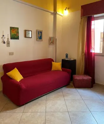 a red couch sitting in a living room at Un Nido Tra Mare e Monti in Partinico