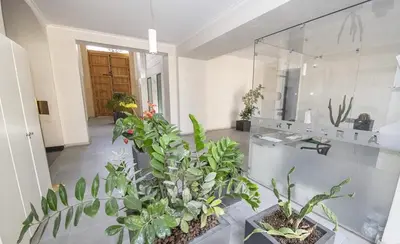a room with a bunch of plants and a mirror at Gran Cancelliere Apartment Parking in Palermo