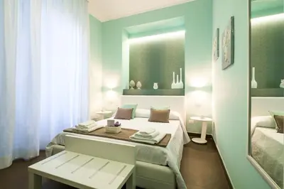 a bedroom with a bed with a bench and a mirror at Gran Cancelliere Apartment Parking in Palermo