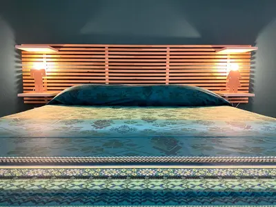 a bedroom with a large bed with a wooden headboard at casa vacanze Sleep Art in Palermo