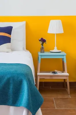 a bedroom with a bed and a table with a lamp at VENTO DI SCIROCCO CASA VACANZE A POCHI METRI DAL MARE in Santa Flavia