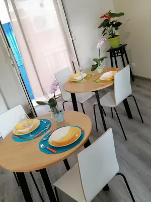 two tables with plates and chairs in a room at La terrazza sul vicolo in Palermo