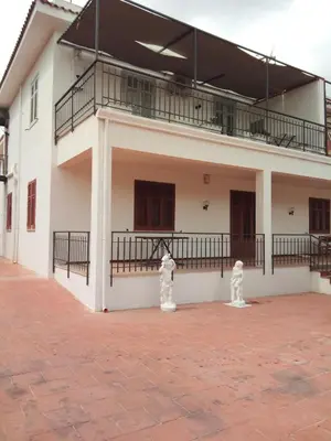 a white building with a balcony on the side at Appartamento a Mondello in Mondello