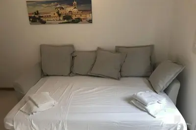 a white bed with two towels on top of it at La Lumia - Al Politeama in Palermo