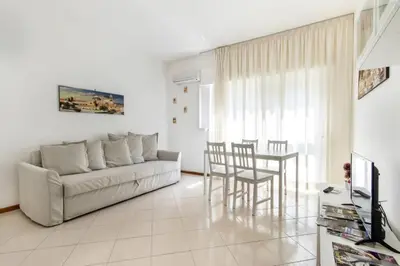 a living room with a couch and a table and chairs at La Lumia - Al Politeama in Palermo