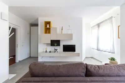 a living room with a couch and a tv at M'Place Apartments in Palermo