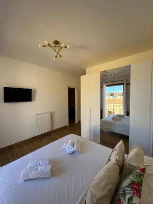 a bedroom with a white bed with towels on it at Made In Sicilia -IN CENTRO, ARIA CONDIZIONATA e NO ZTL- CITY CENTRE, AIRCON and NO LTZ in Castellammare del Golfo