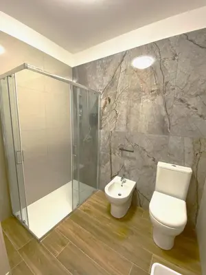 a bathroom with a shower and a toilet and a sink at Medusa -IN CENTRO, ARIA CONDIZIONATA e NO ZTL -CITY CENTRE, AIRCON, NO LTZ in Castellammare del Golfo