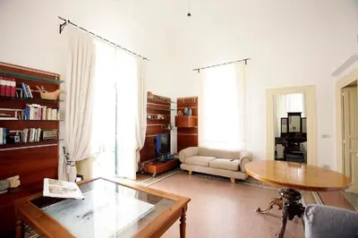 a living room with a table and a couch at CUBA'S ART HOUSE in Palermo