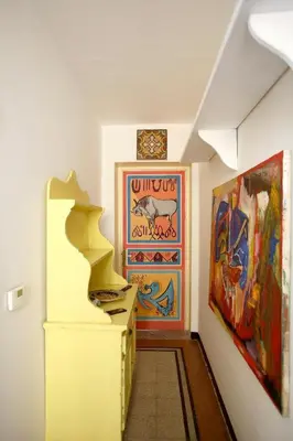 a hallway with paintings on the wall and a painting at CUBA'S ART HOUSE in Palermo