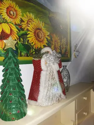 a table with two christmas vases and a christmas tree on it at Franco-Home in Palermo