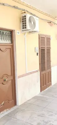 a building with a door and an air conditioner at Casa Giusi in Sferracavallo