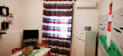 a small room with a table and a refrigerator at Casa Giusi in Sferracavallo