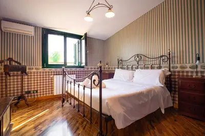 a bedroom with a bed with white sheets and a window at Solemar Sicilia - Villa Anastasia in Ficarazzi