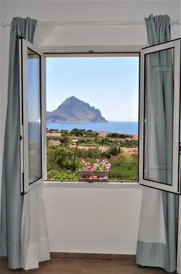 a window with a view of the ocean at Casa Vacanze Monte Cofano in Macari