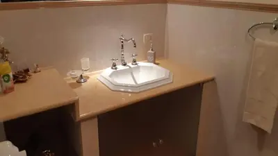 a bathroom with a white sink on a counter at Carini Luxury Apartment vicino aereoporto e al mare in Carini