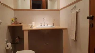 a bathroom with a sink and a toilet at Carini Luxury Apartment vicino aereoporto e al mare in Carini
