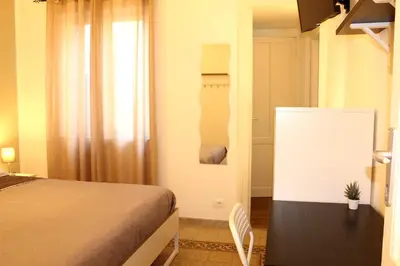 a bedroom with a bed and a window and a chair at Cosmo Apartment in Palermo