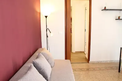 a living room with a couch and a lamp at Cosmo Apartment in Palermo