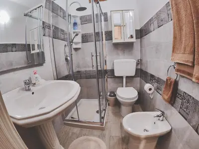 a bathroom with a shower and a sink and a toilet at Casa vacanza Terra Mare in Castellammare del Golfo