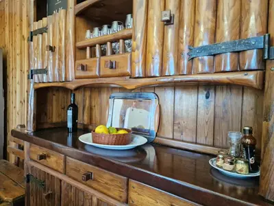 a counter with a bowl of fruit and a bottle of wine at Villa Mazzamuto in Altavilla Milicia