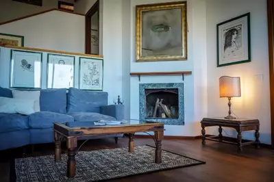 a living room with a blue couch and a table at Villa Rosa Bianca in Palermo