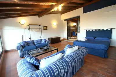 a living room with blue couches and a couch at Villa Rosa Bianca in Palermo