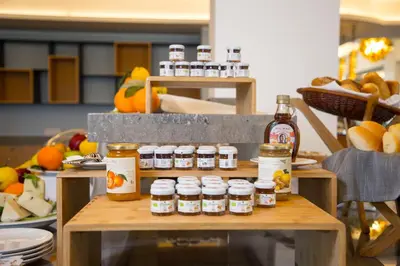 a table with several jars of honey on it at Principe Alogna Hotel & SPA in Altavilla Milicia