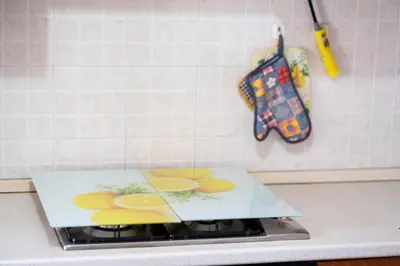 a cutting board on top of a stove in a kitchen at Casa Laura di fronte la Tonnara in San Vito lo Capo