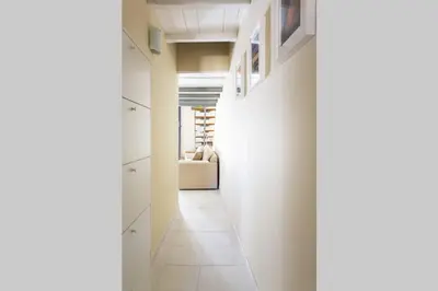 a hallway with white cabinets and a couch in a room at Da Mari e Paolo in Palermo
