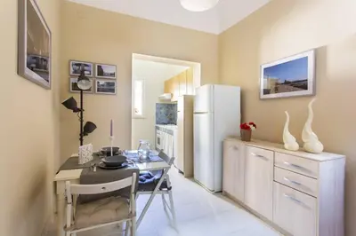 a dining room with a table and a refrigerator at Da Mari e Paolo in Palermo
