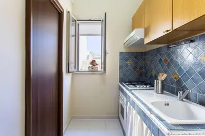 a small kitchen with a sink and a window at Da Mari e Paolo in Palermo