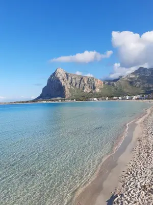 a beach in cape town with a mountain in the background at Casa vacanza da Samuele in San Vito lo Capo