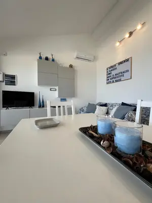 a white table with a tray of food on it at Villa Futura in Scopello