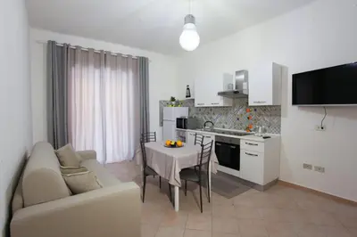 a kitchen and living room with a couch and a table at Afrodite appartamento Ballarò in Palermo